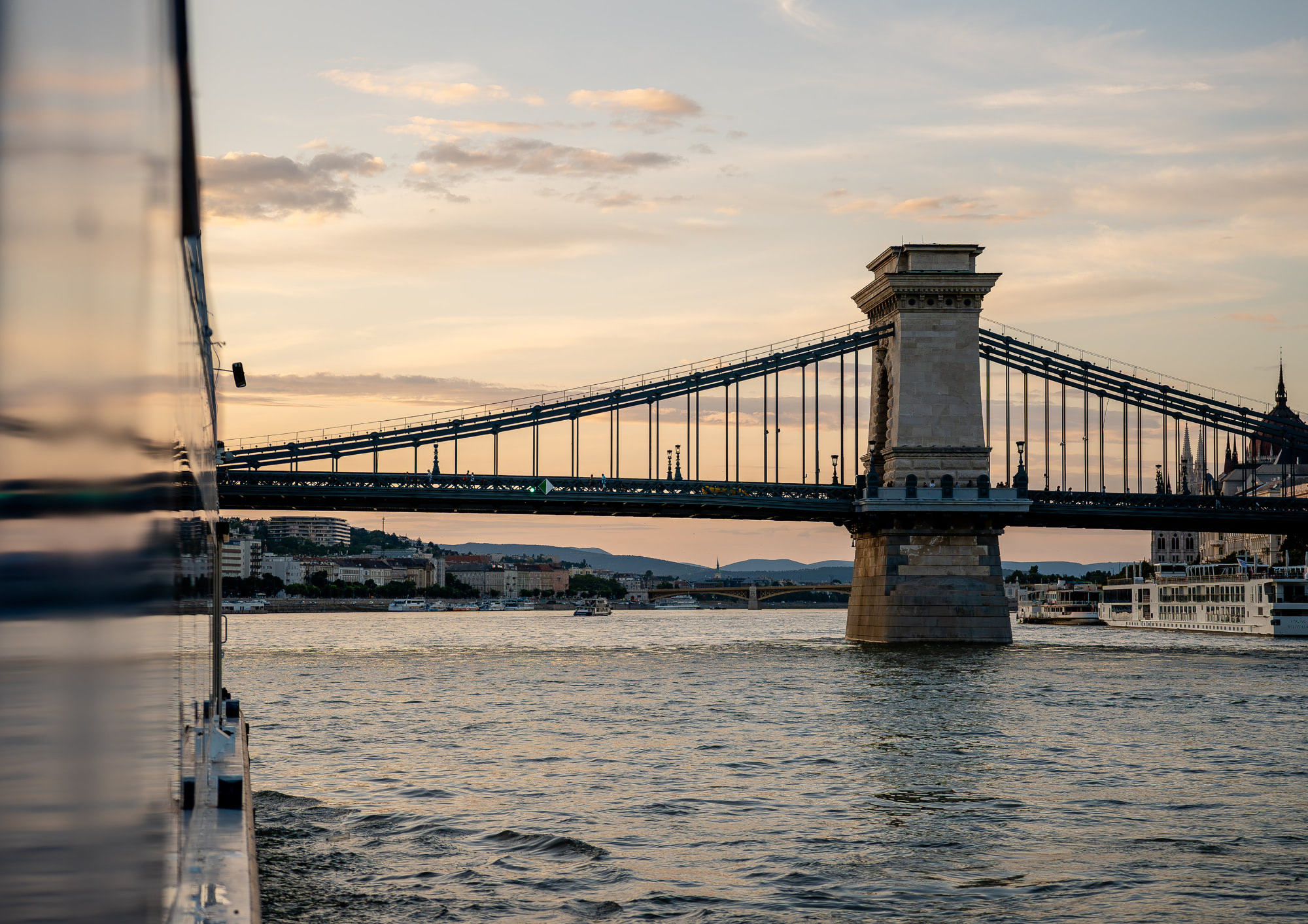 Sunset view of Budapest’s Chain Bridge from a Bud By Boat cruise on the Danube.