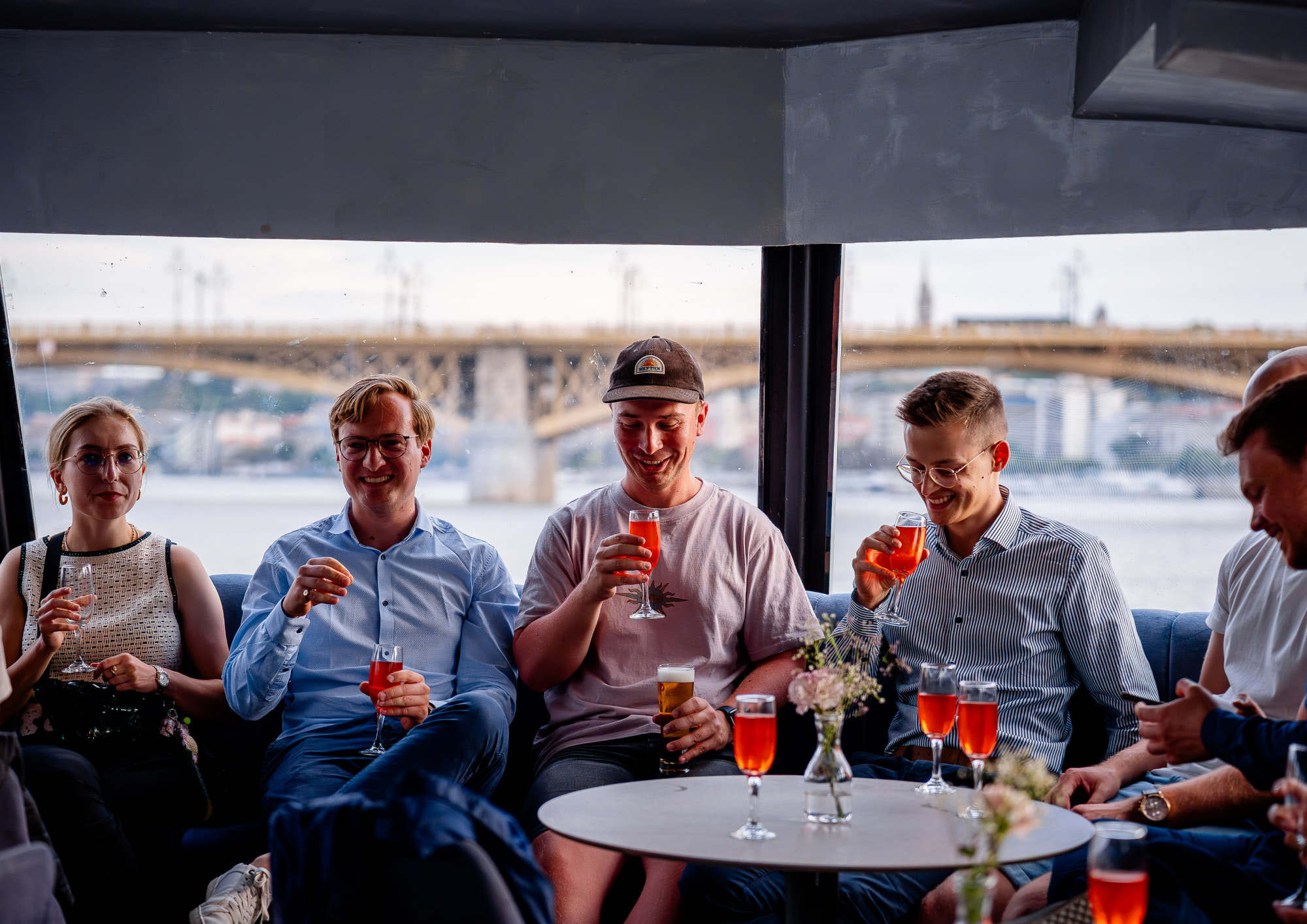 Friends enjoying prosecco and house spritzers inside a Bud By Boat sightseeing cruise.